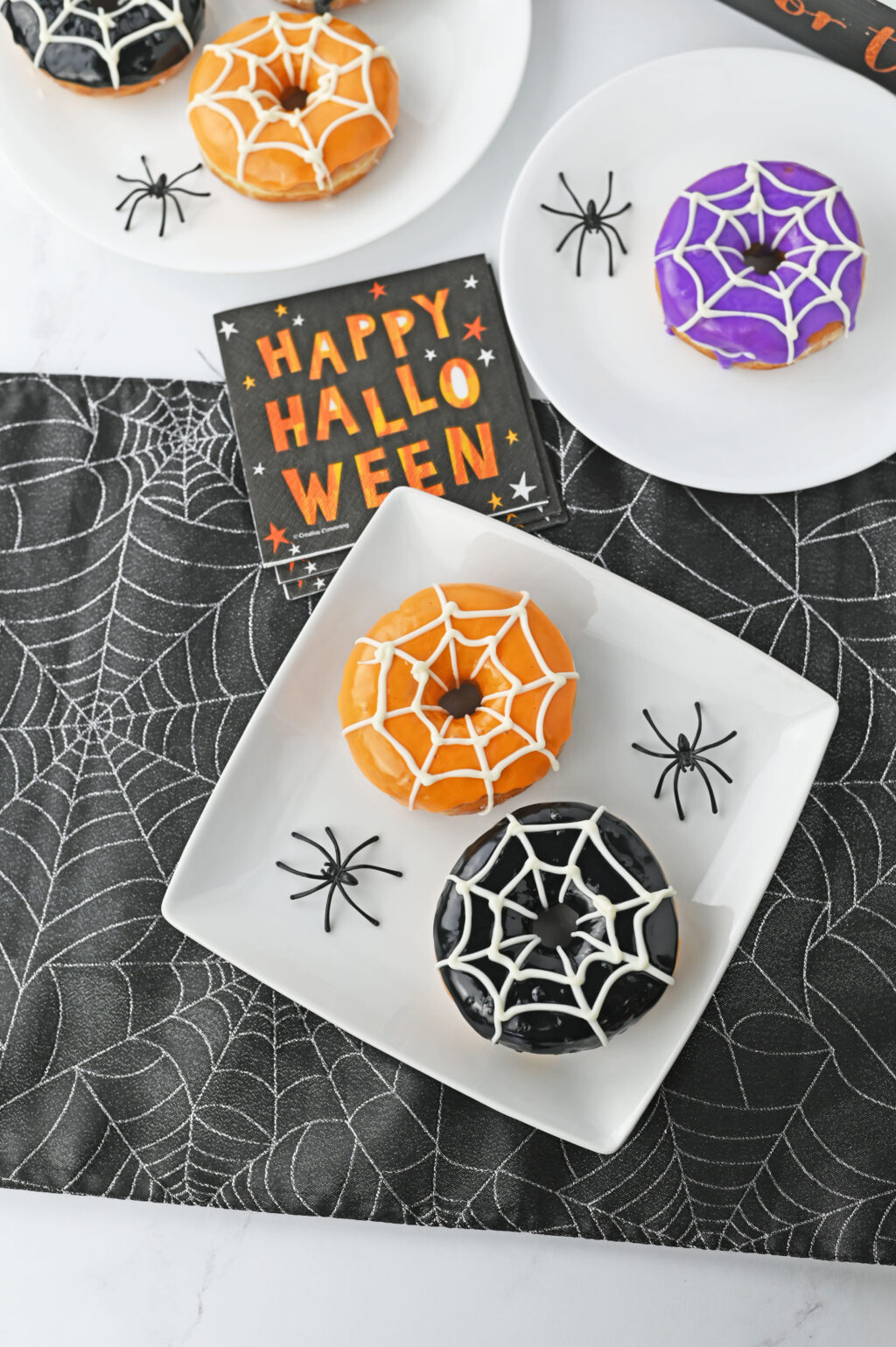 colorful spiderweb donuts on white plate