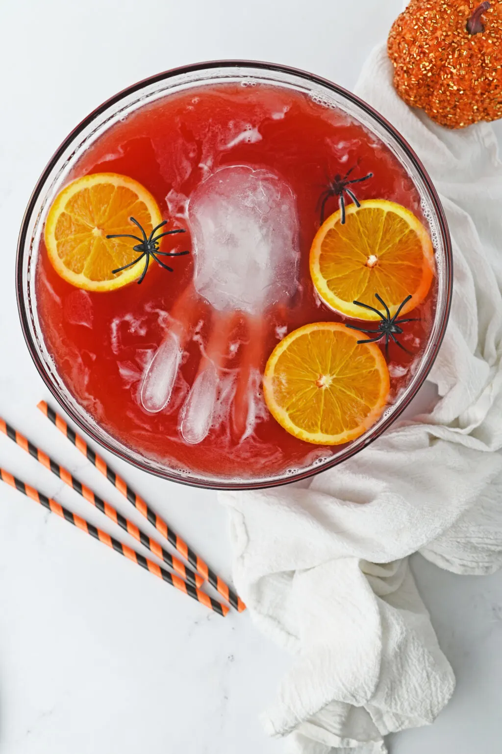 bowl of red spooky halloween punch with frozen ice hand