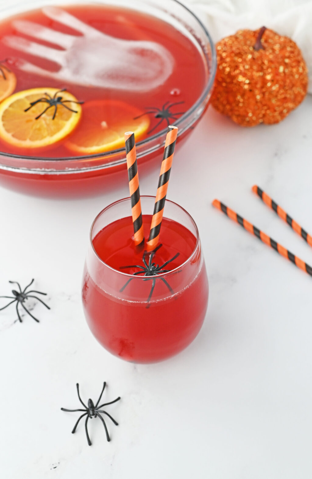 spooky halloween punch in glass with halloween straws