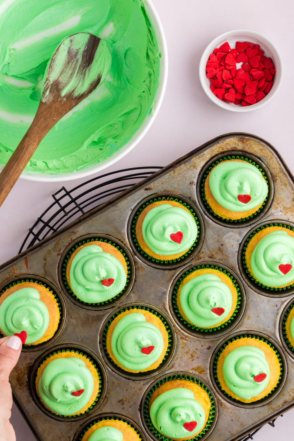grinch cupcakes decorated in muffin tin