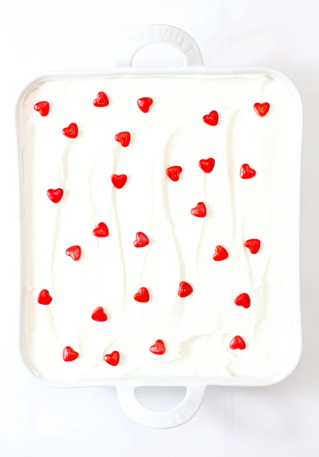 cool whip layer with red sprinkle hearts on top of grinch lush dessert