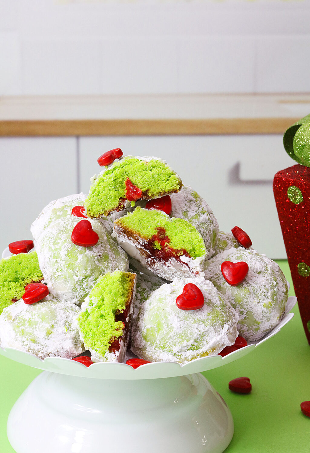 grinch snowball cookies stacked on serving tray