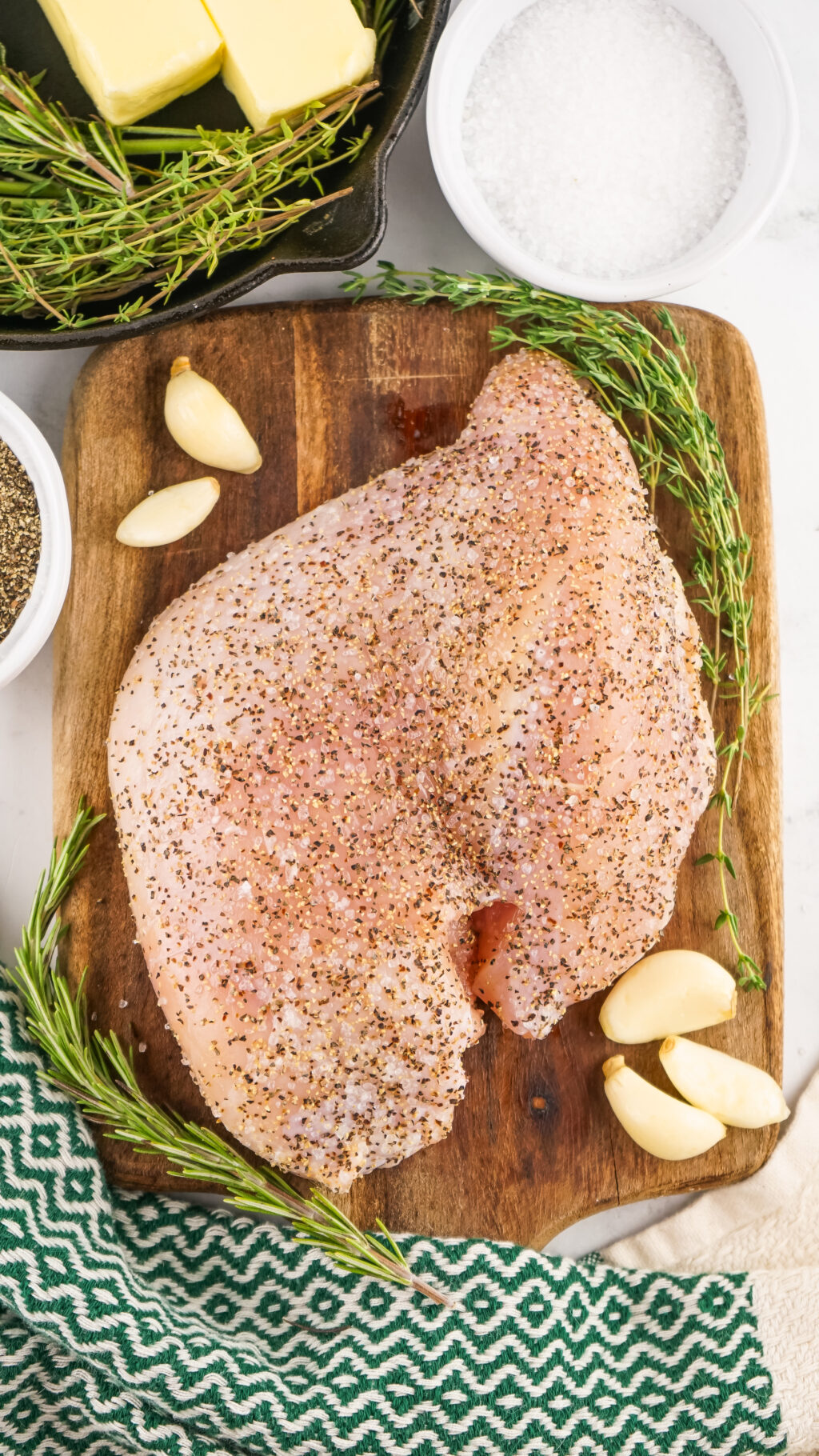 seasoned raw turkey breast on cutting board