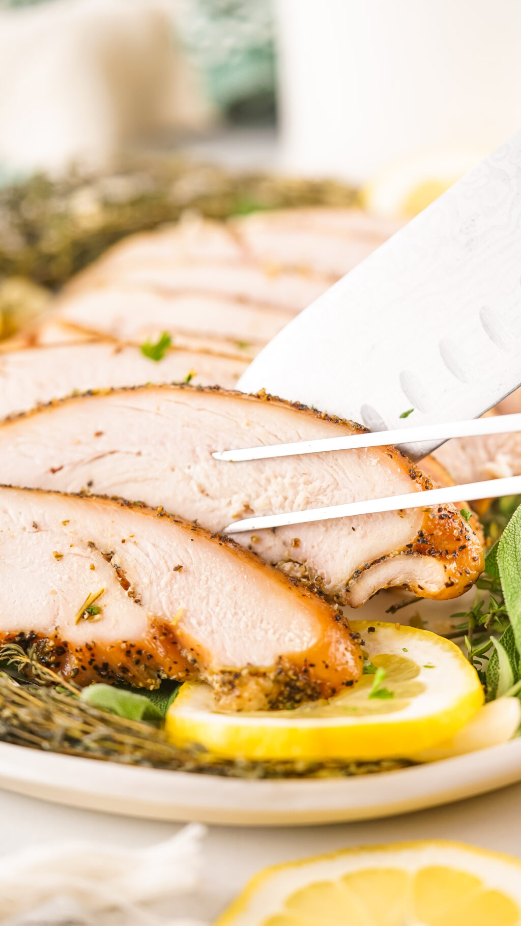 knife cutting slices of smoked turkey breast