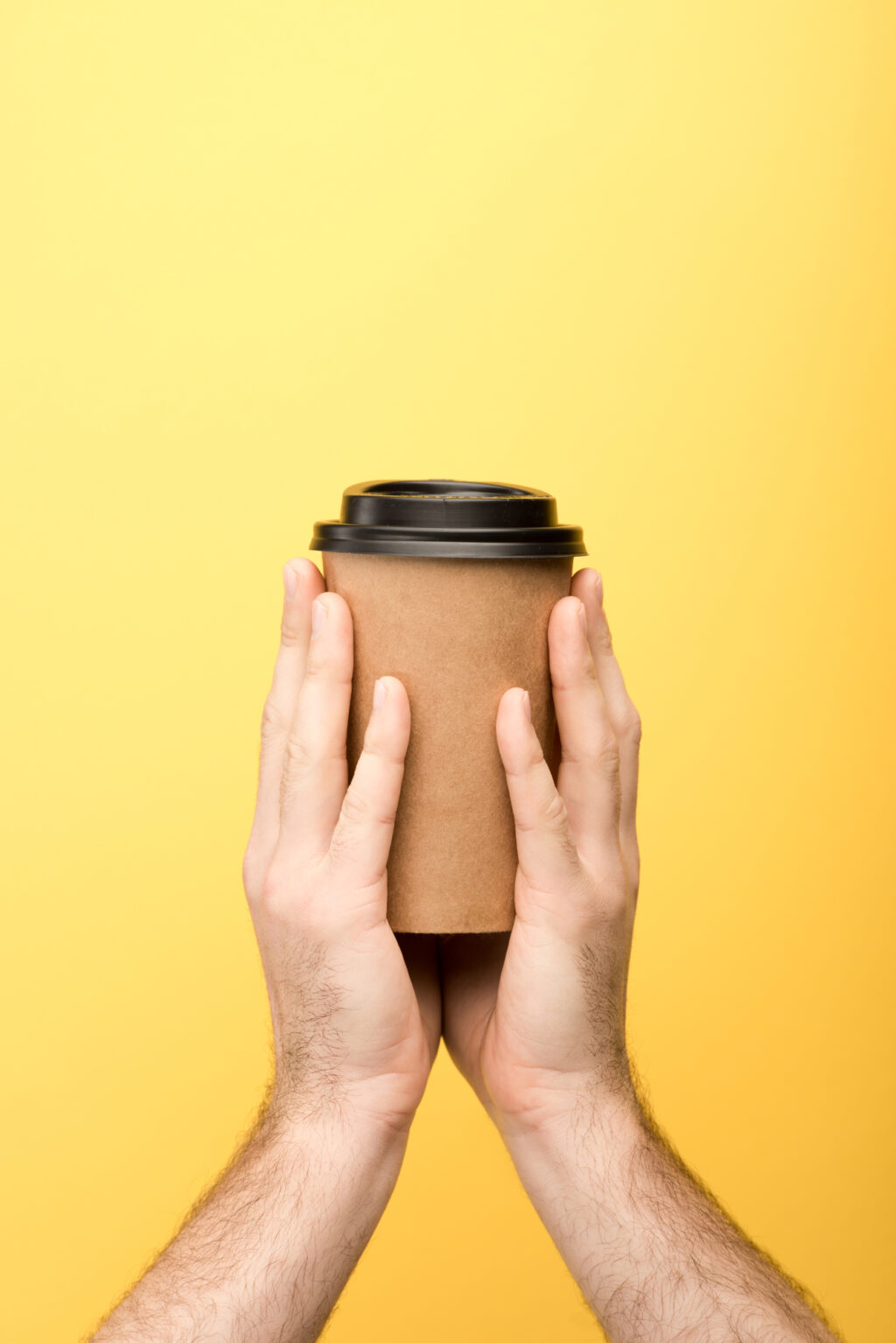 man's hand holding coffee cup