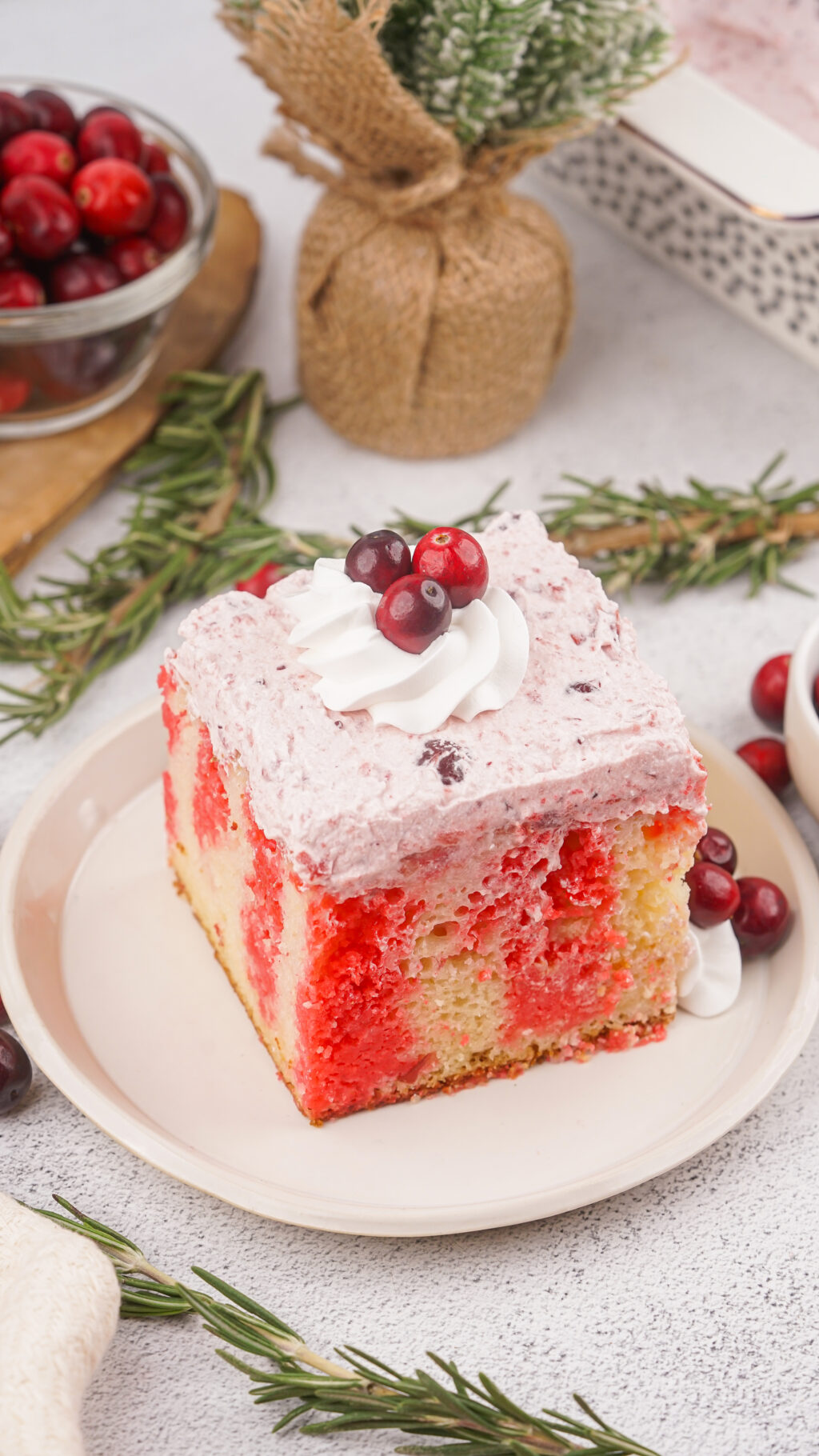 slice of cranberry poke cake on white plate
