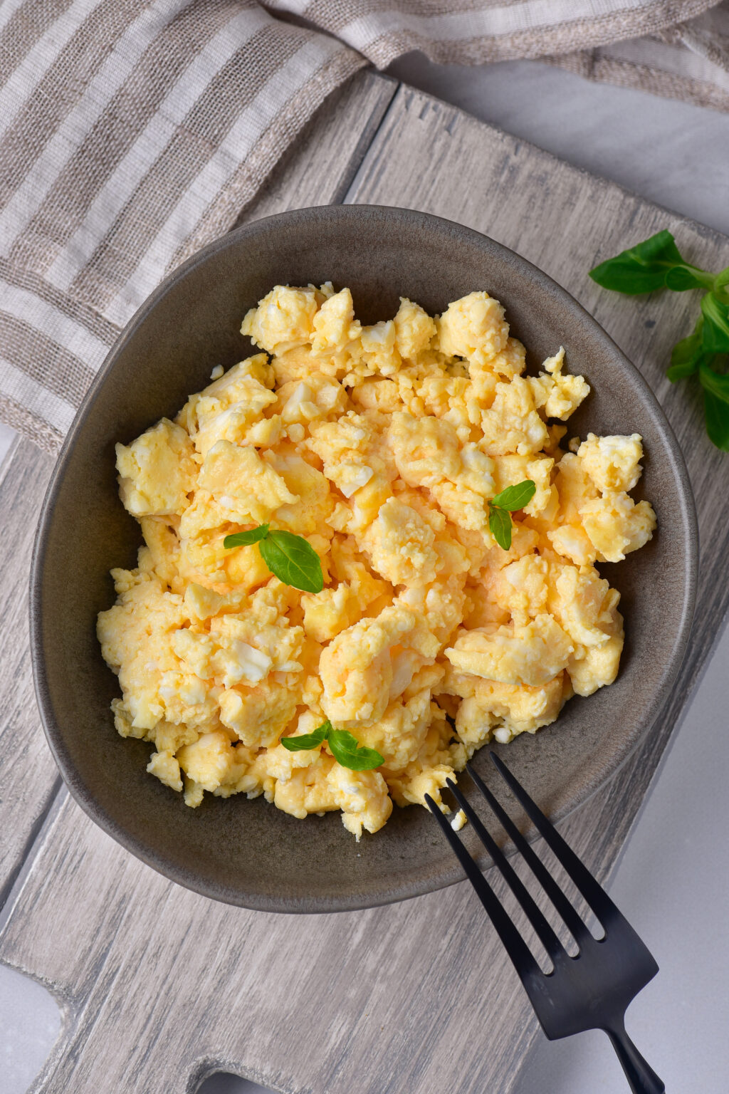 microwave scrambled eggs in a grey bowl