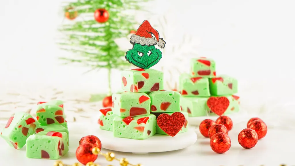 grinch christmas nougat candy stacked on white plate