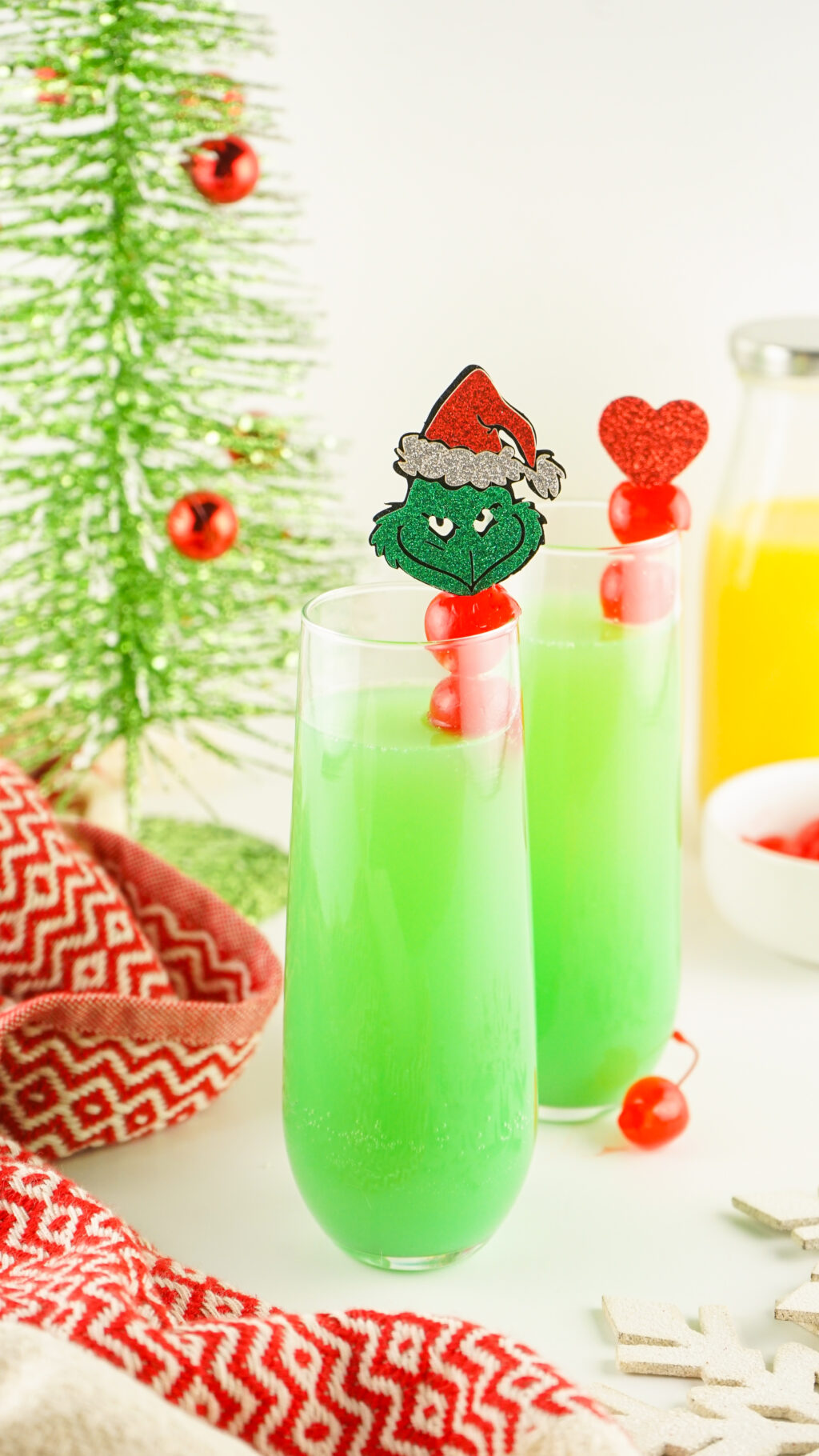 tall glasses filled with green grinch mimosa 