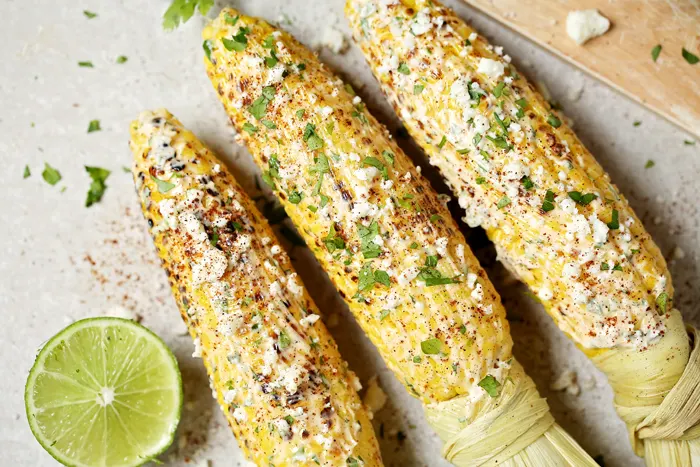 mexican street corn on the cob on a table