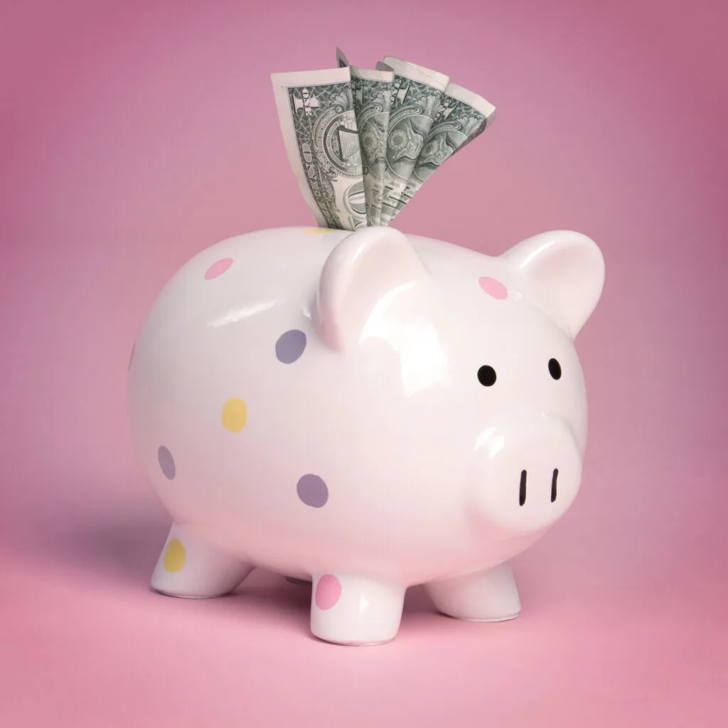 pink piggy bank with money inside