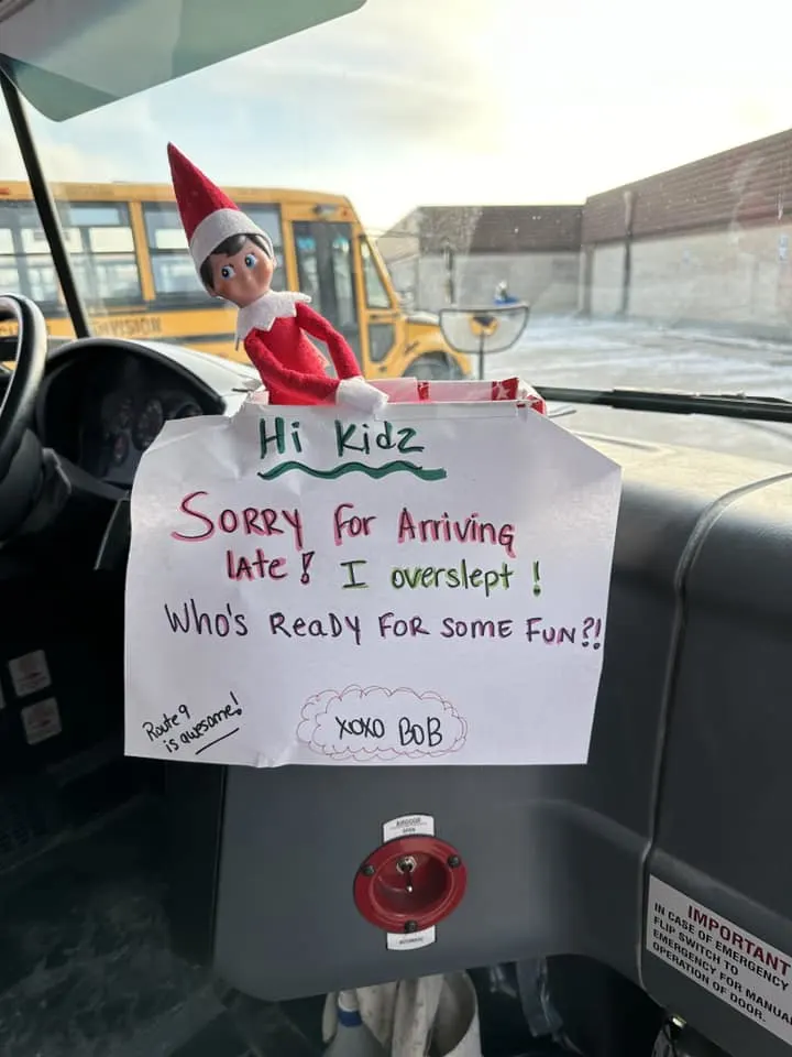 elf on a bus with letter saying they are sorry