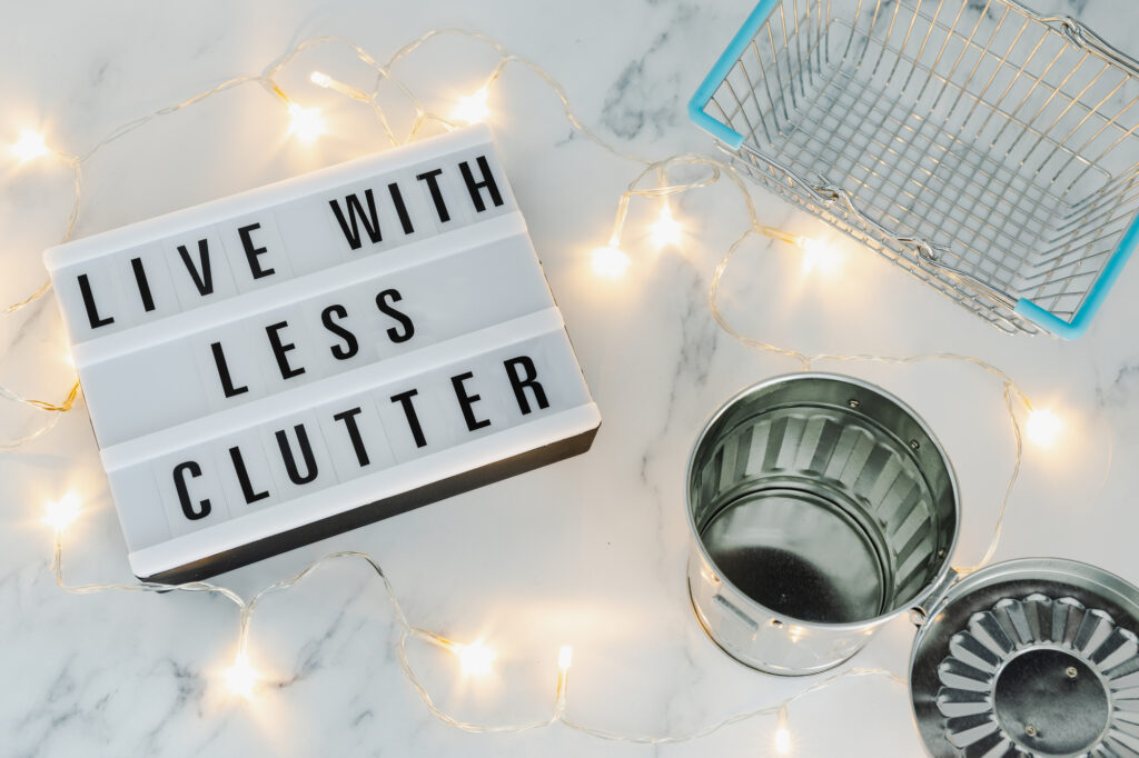 sign that says live with less clutter