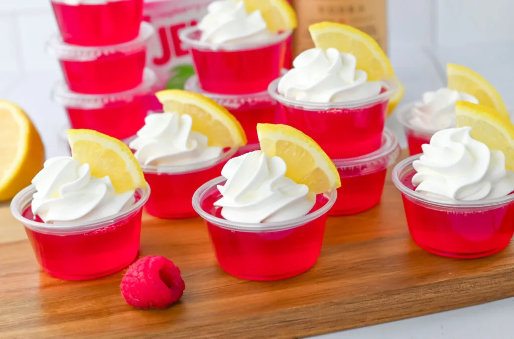 raspberry lemonade jello shots on wooden serving tray