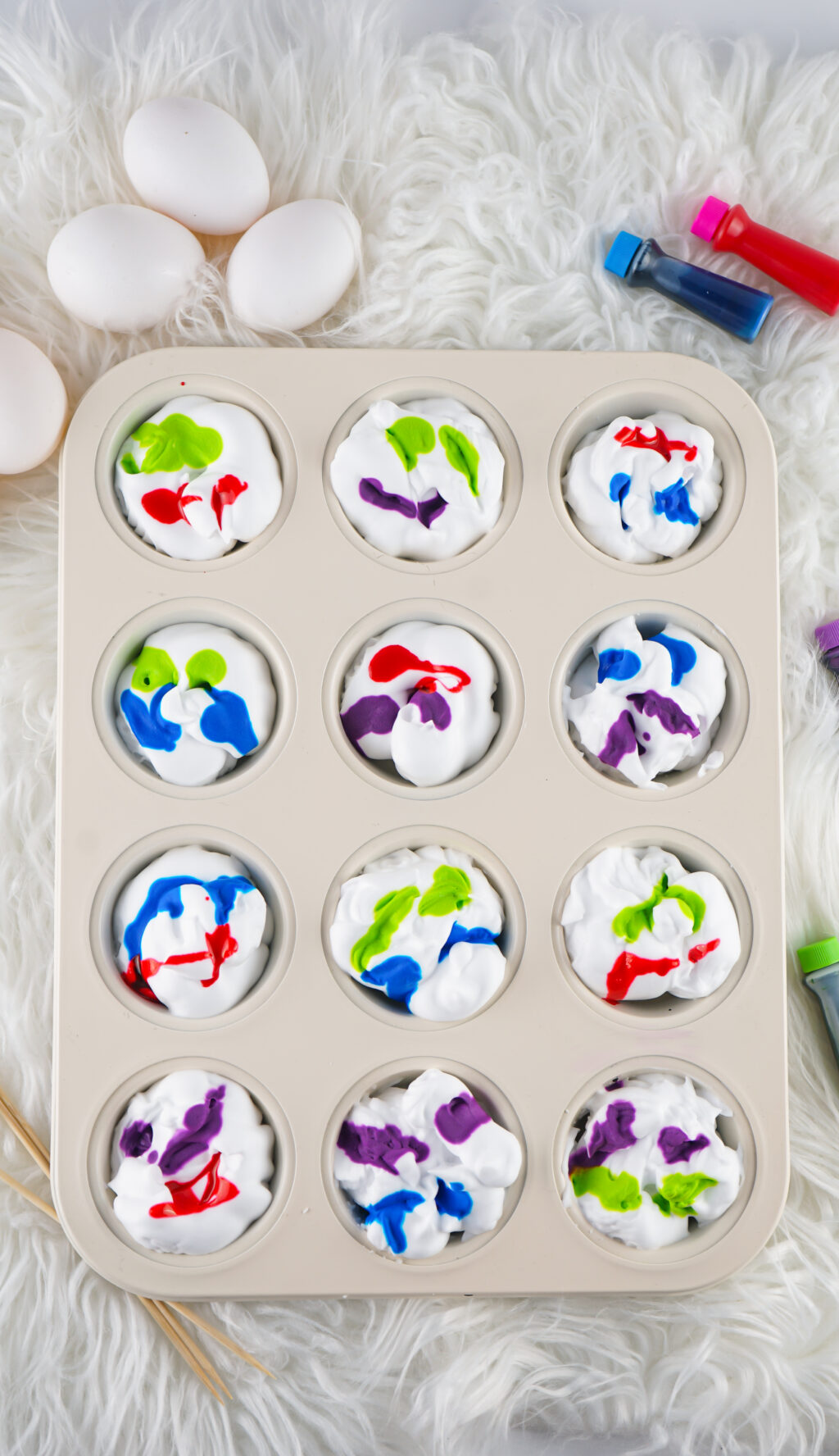 shaving cream with food coloring in muffin tin